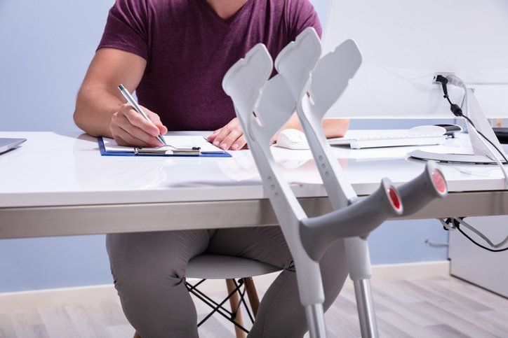 Crutches Leaning On Table In Front Of Handicapped Patient