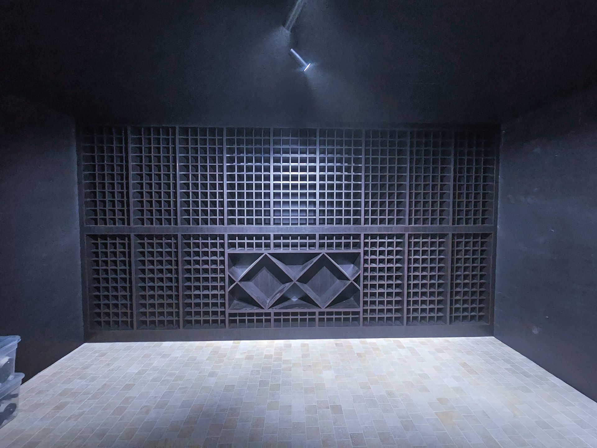 A dark room with a lot of shelves on the wall