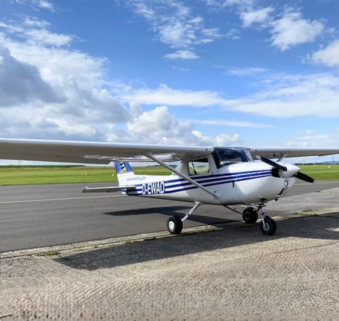 A small plane is parked on the side of the road