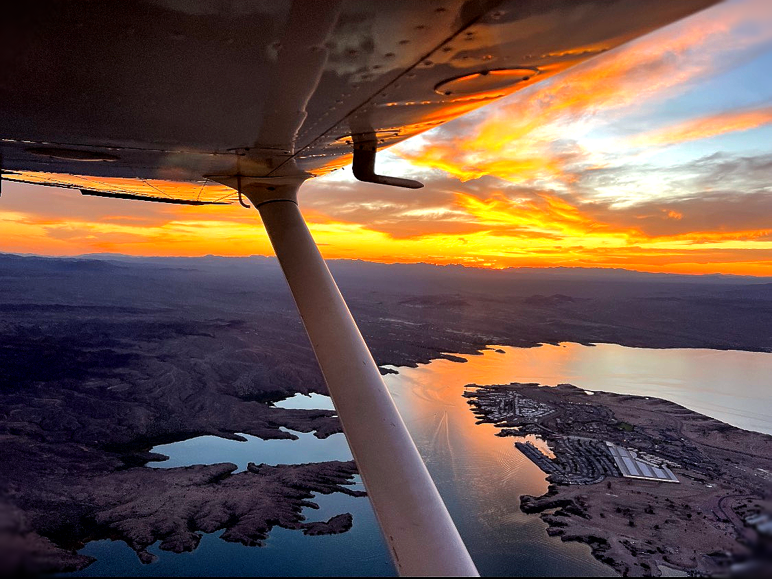 A small propeller plane is parked on a runway.