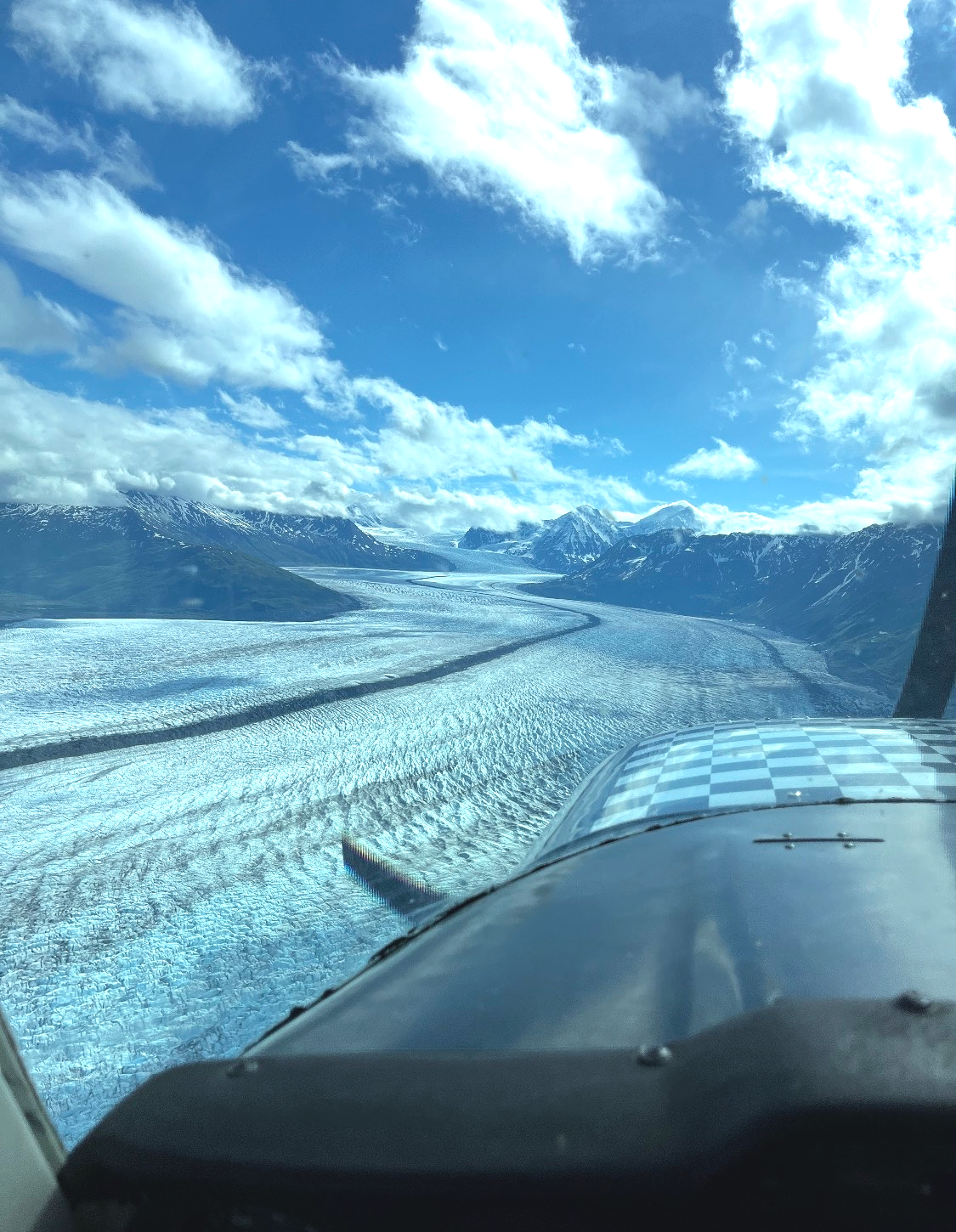 A man in a suit and hat is waving his hand.