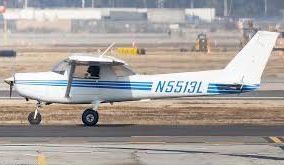 A plane is flying through a blue sky with smoke trails
