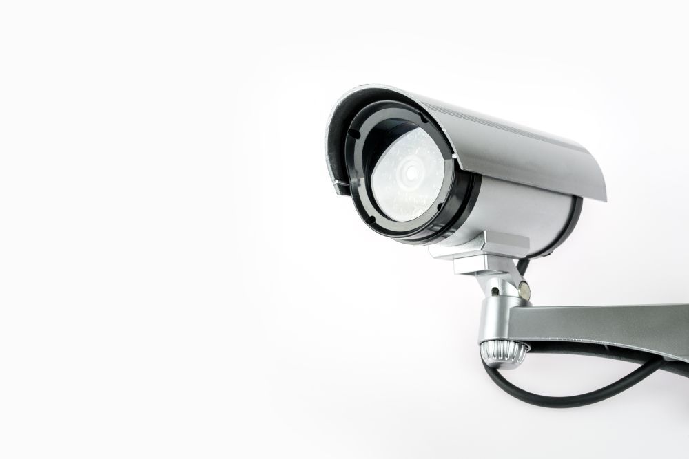 Security Camera Mounted on A Wall; Gray and Black, Lens Facing Forward — CQR Locksmiths in Wee Waa, NSW