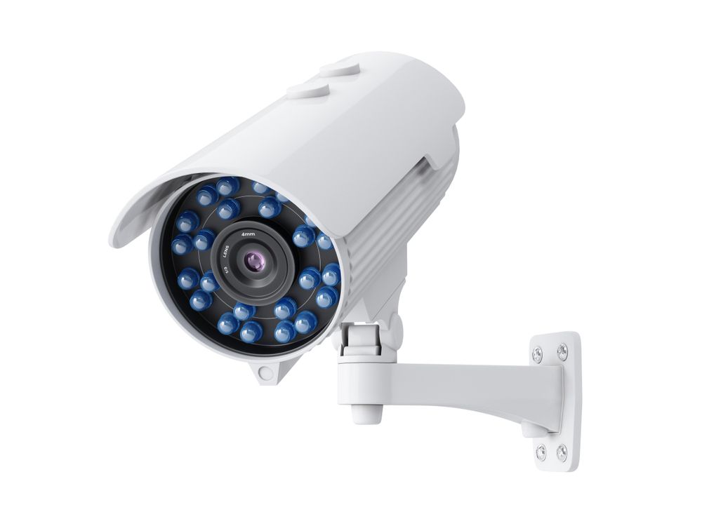 White Security Camera Mounted on A Wall, with Visible Blue Infrared Lights — CQR Locksmiths in Wee Waa, NSW