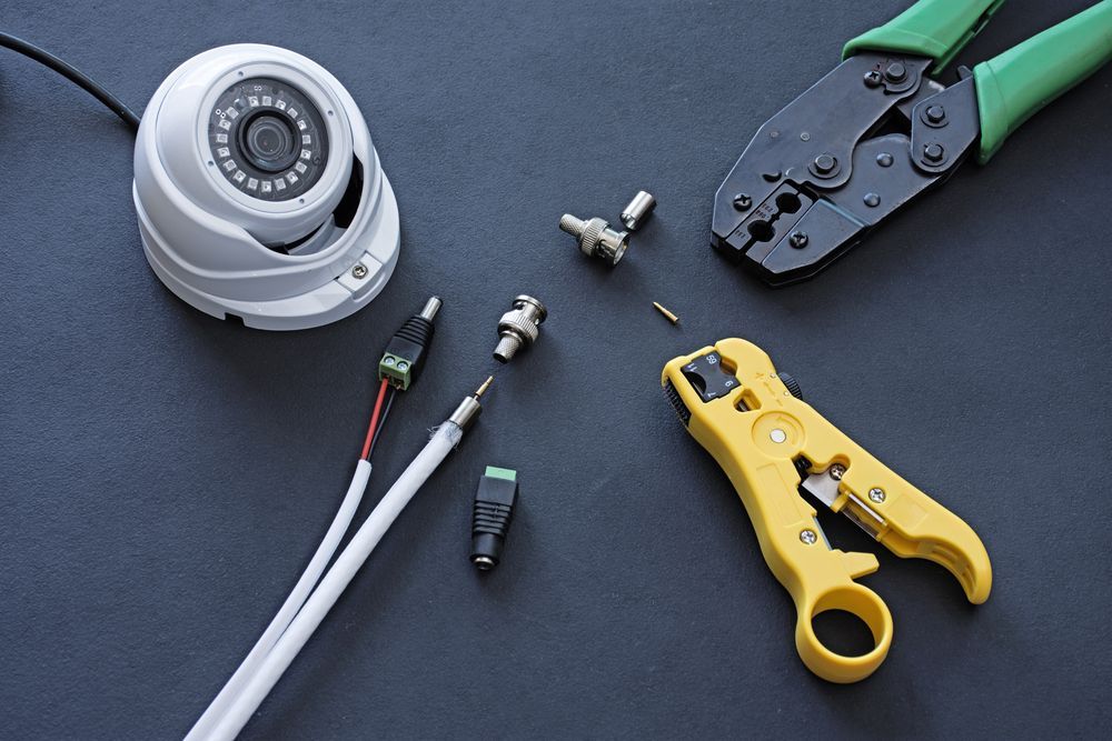 Security Camera with Tools and Connectors on A Dark Surface — CQR Locksmiths in Goondiwindi, QLD