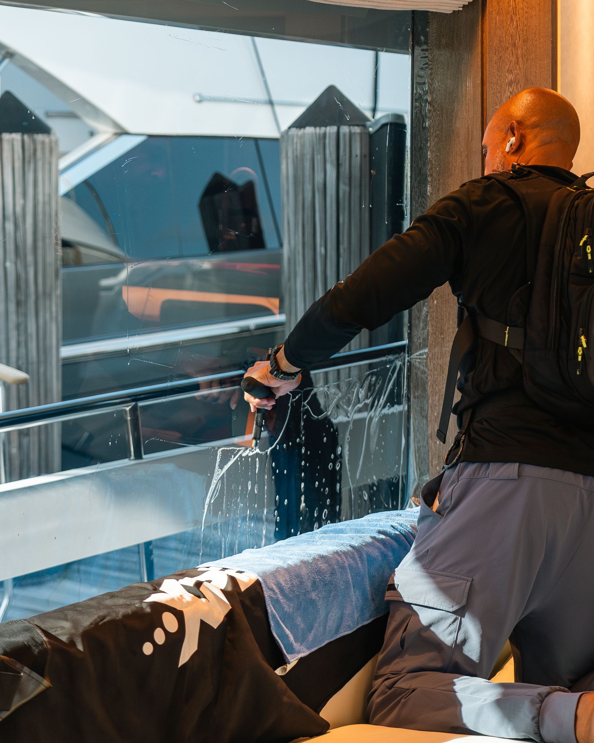 a man is cleaning the windows of a car at chicago auto pros .