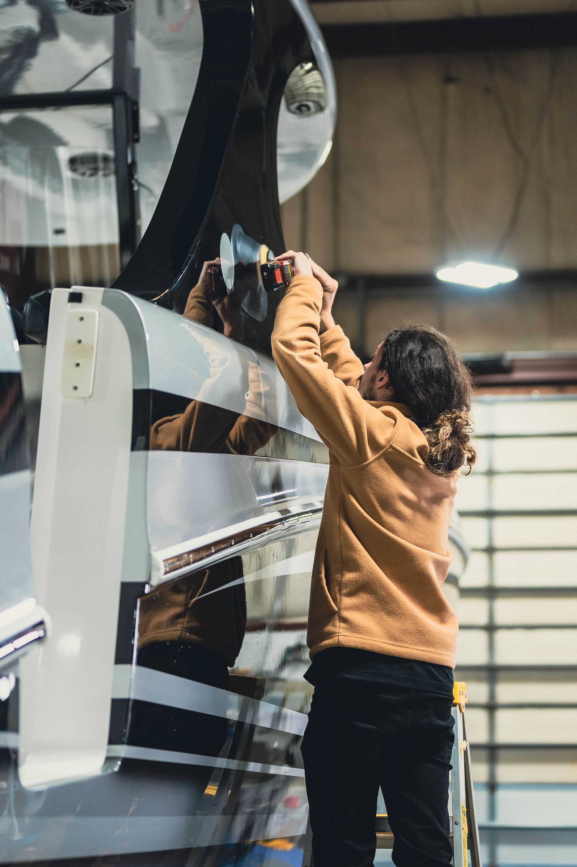 a red sports car is parked in a garage next to a black car .