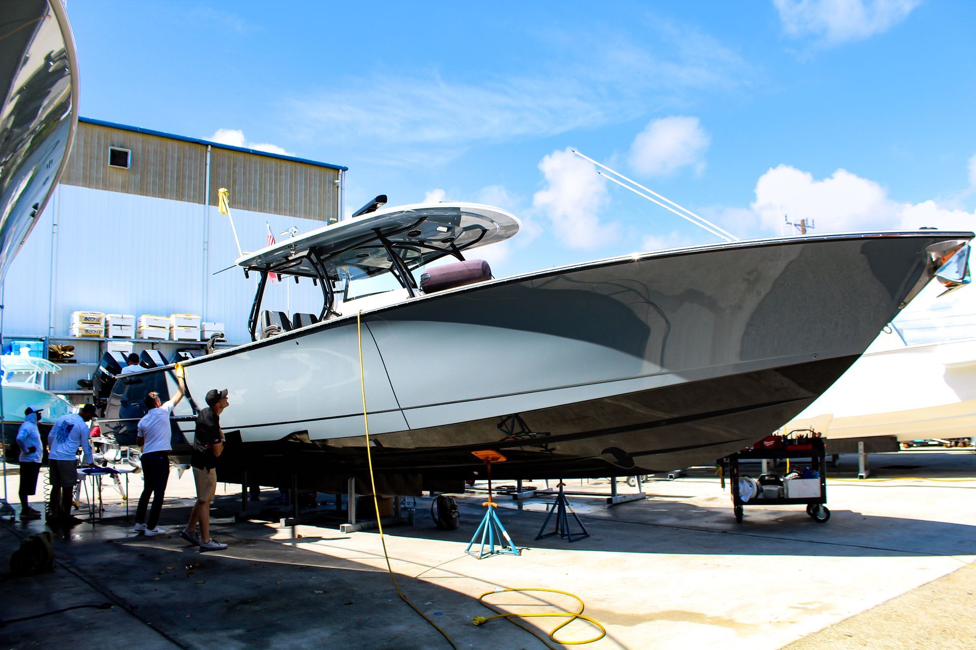 Two men are working on a red sports car at chicago auto pros
