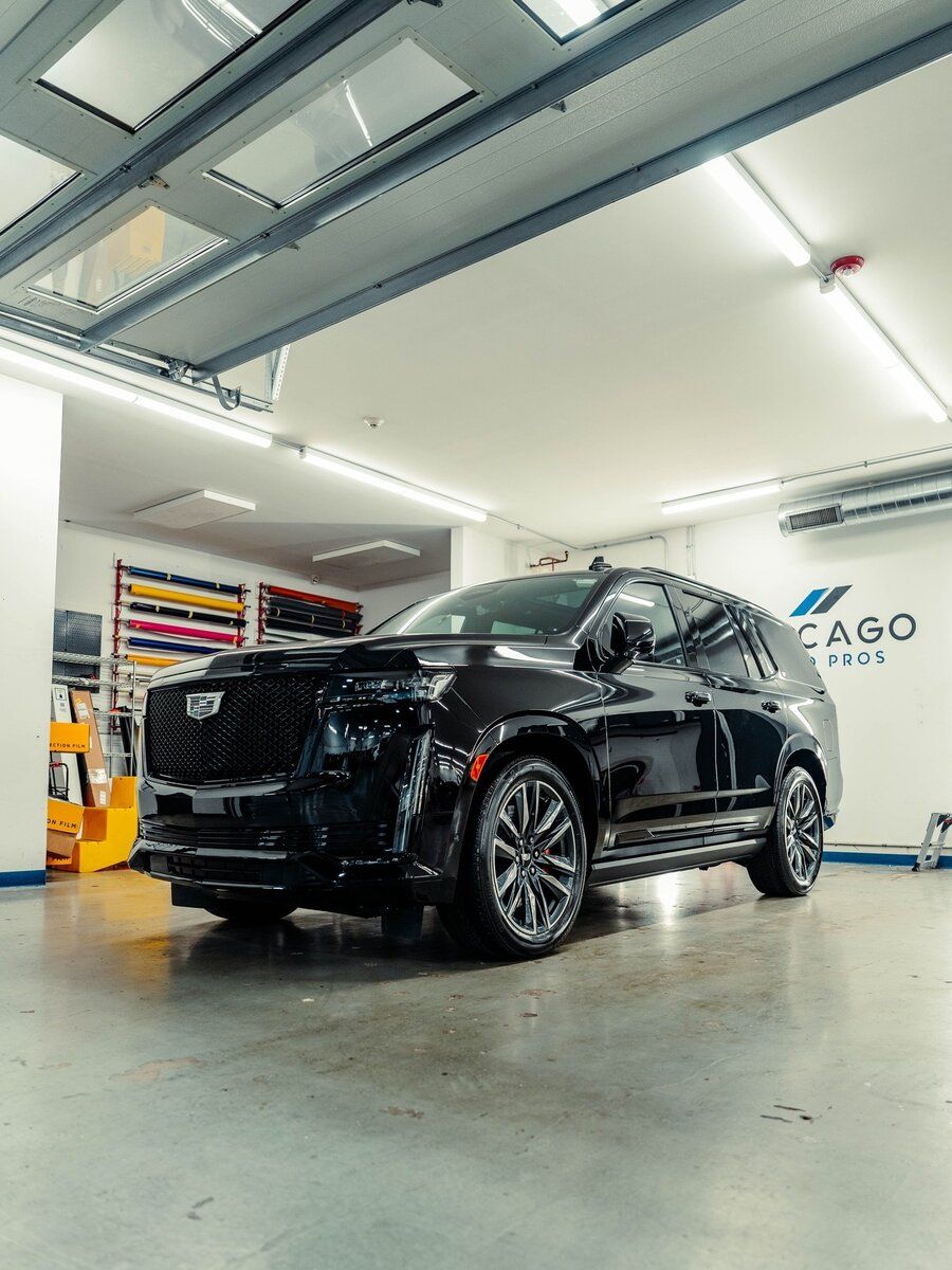 A black suv is parked in a garage.