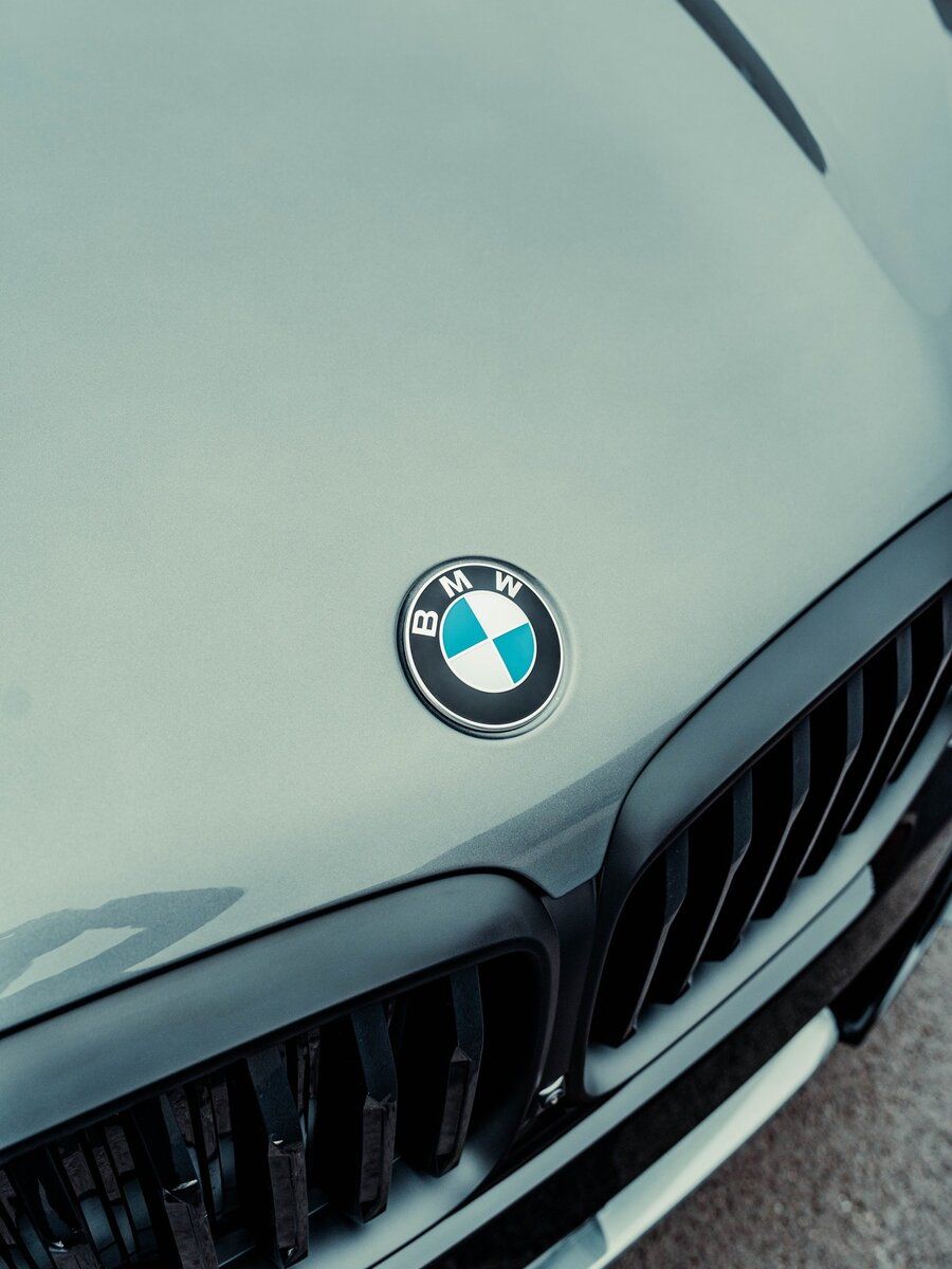 A close up of a bmw emblem on the hood of a car