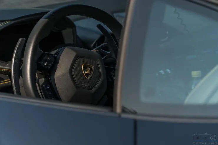 A close up of a steering wheel in a car