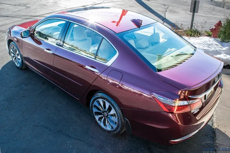 A purple honda accord is parked in a parking lot