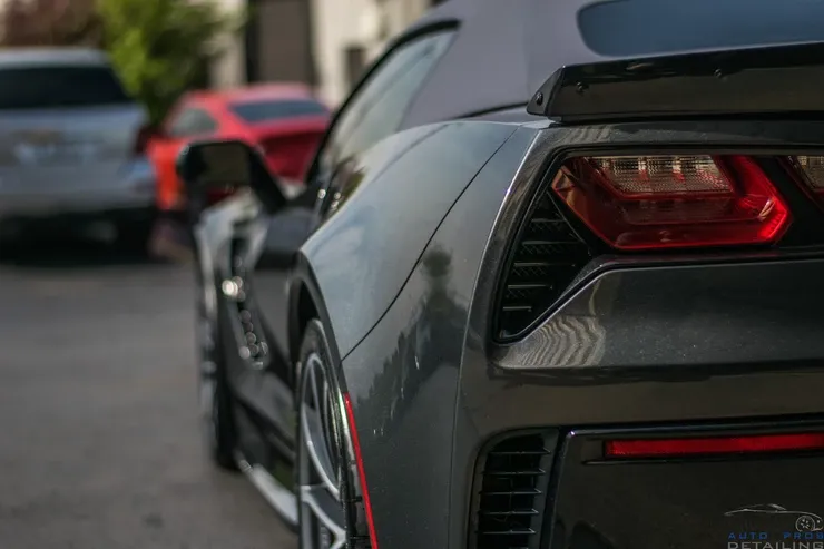 A black sports car is parked on the side of the road.