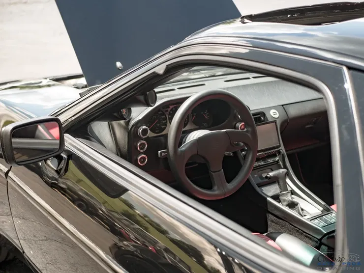 The inside of a black car with the hood open