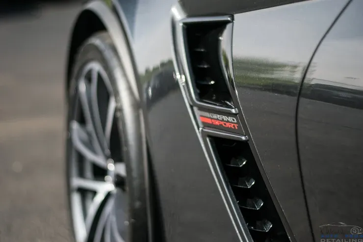 A close up of the side of a black sports car