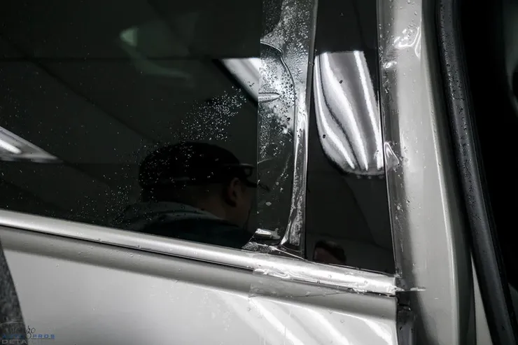 A man is looking out of a car window.