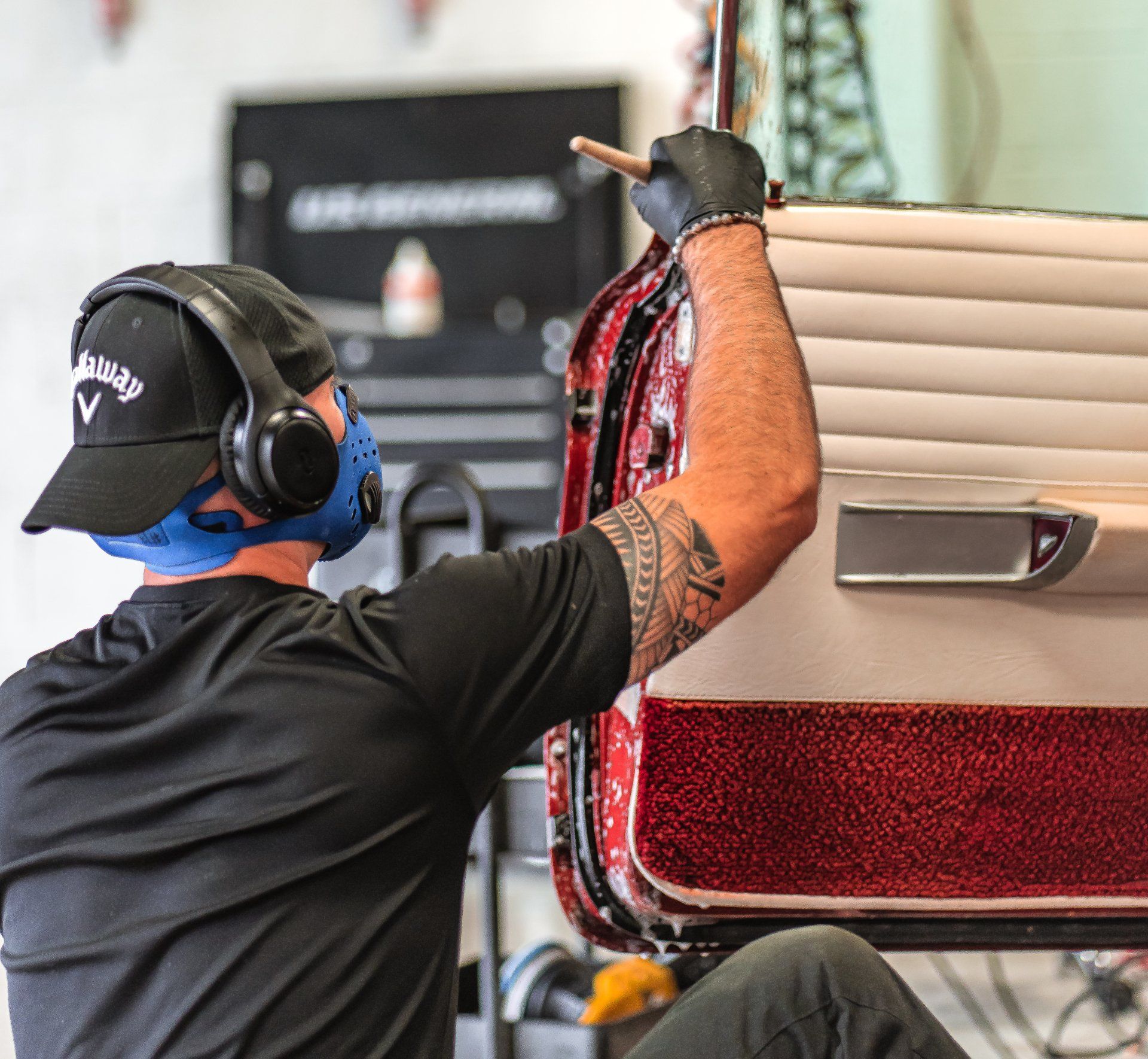 A man wearing headphones and a hat with the letter v on it