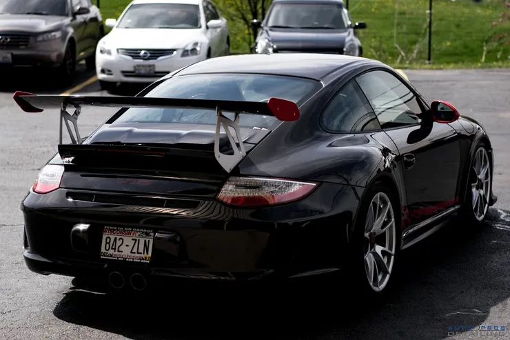 A black sports car with a license plate that says 642 zlw