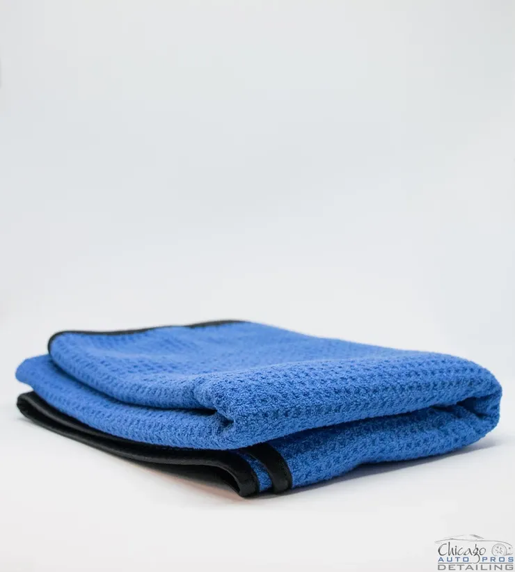 A blue towel is laying on a white surface
