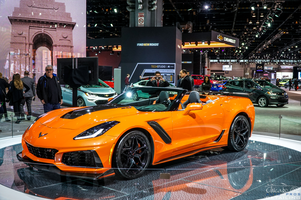 A corvette convertible is on display at a car show.