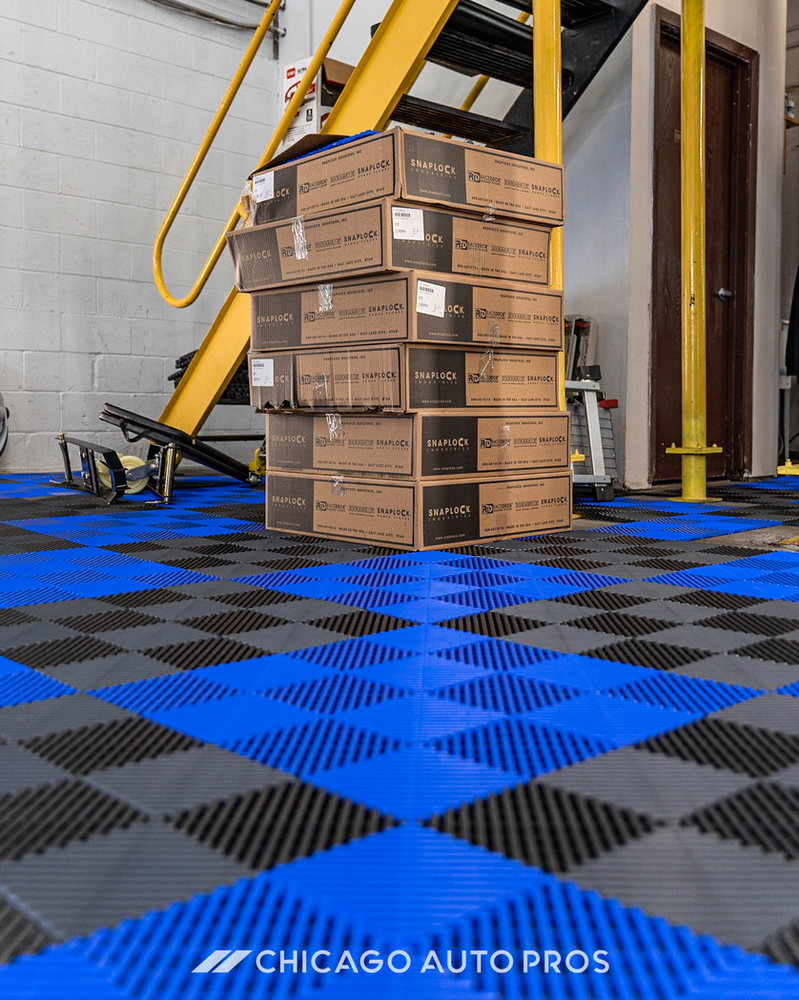 A stack of boxes sitting on top of a blue and black checkered floor ..