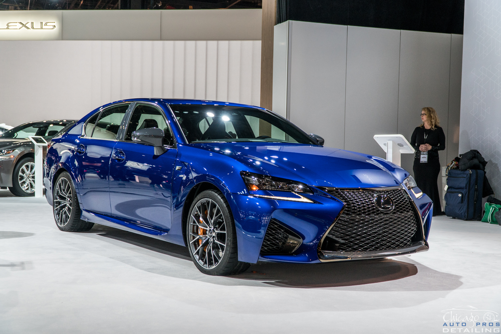A blue lexus is on display at a car show.