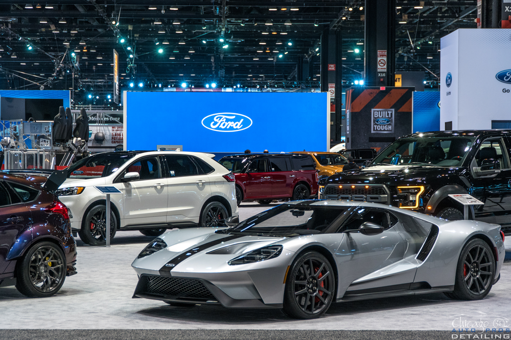 A ford car is on display at a car show.