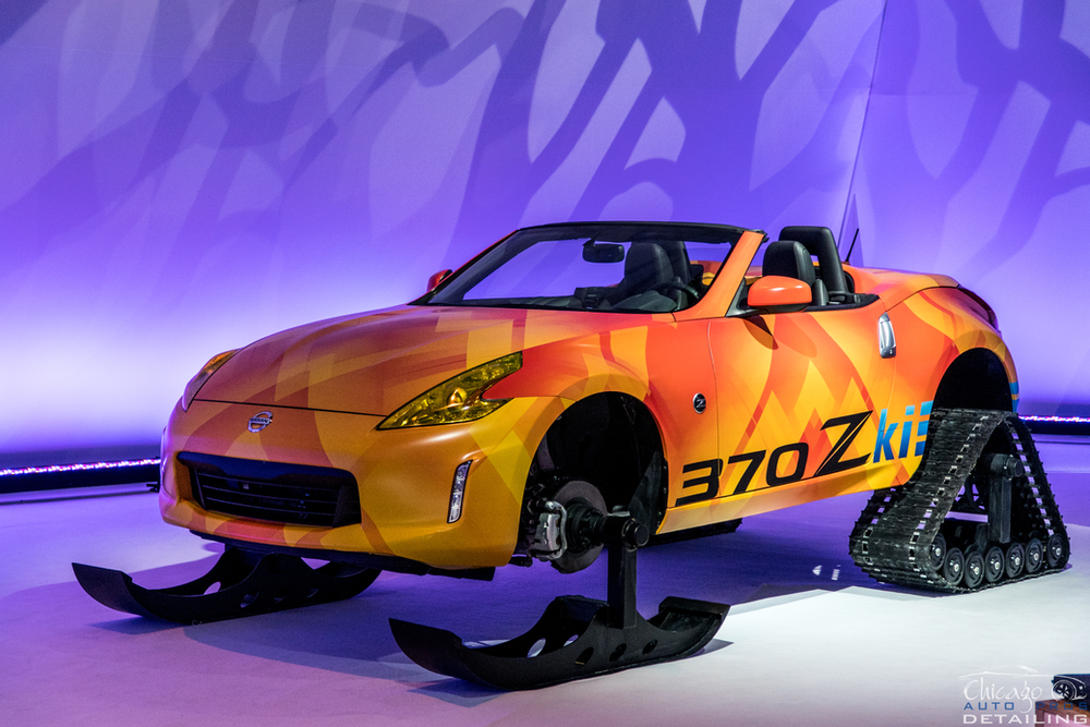 A nissan 370z with snow tracks attached to it