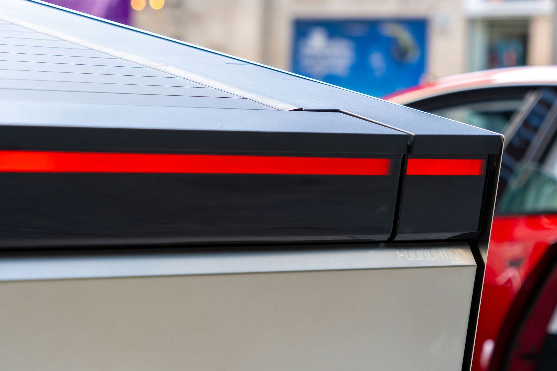 A close up of the back of a tesla model s truck.