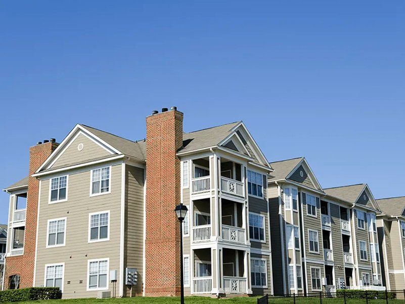 A large apartment building with a lot of windows and balconies