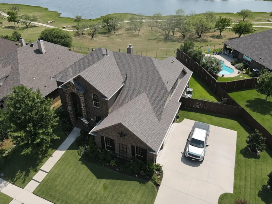 An aerial view of a house with a truck parked in front of it