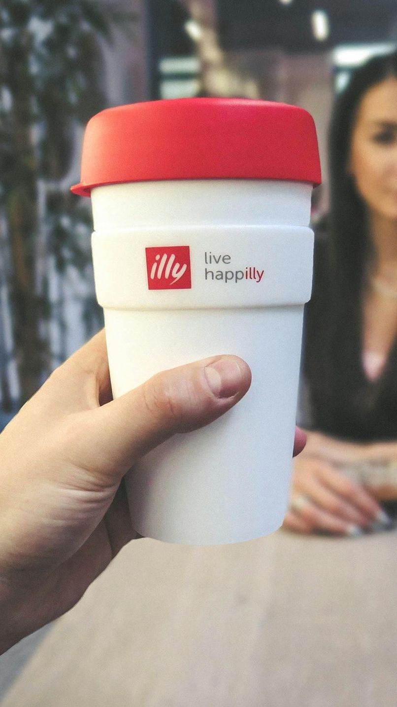 white and red branded coffee mug