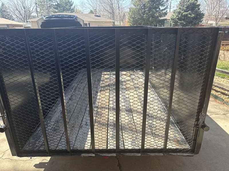 An empty trailer with a metal fence around it