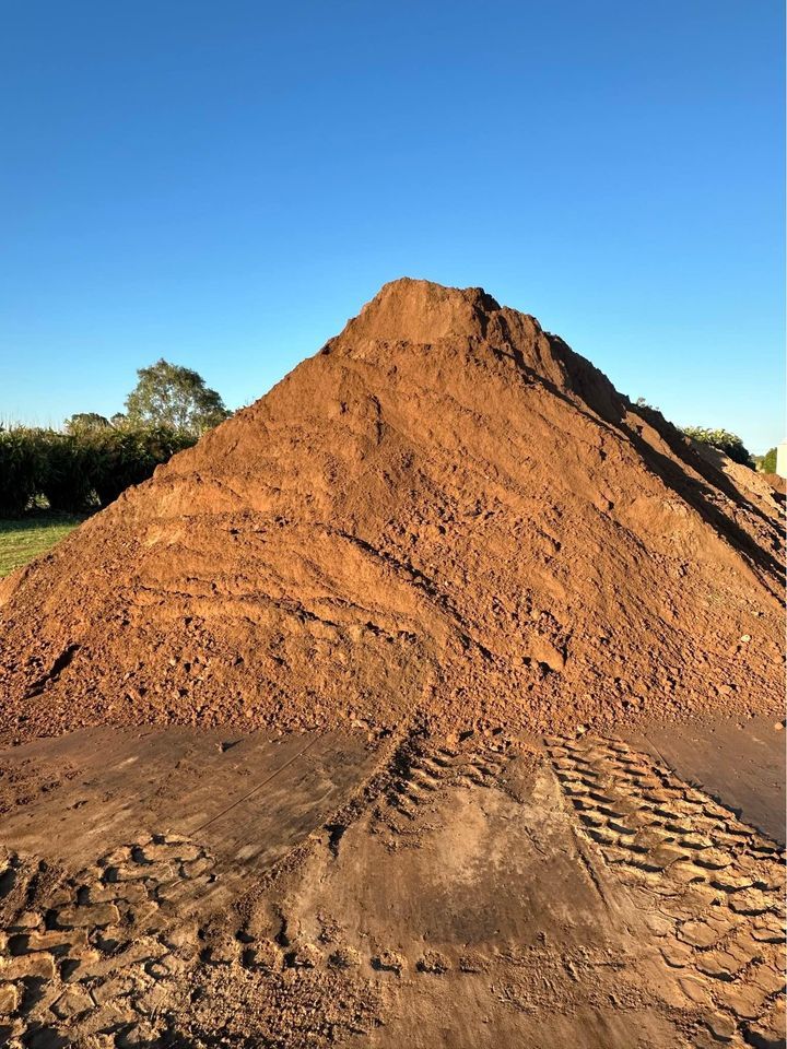 A Dump Truck Is Being Loaded with A Large Pile of Dirt — A1 Tree Service in Kensington, QLD