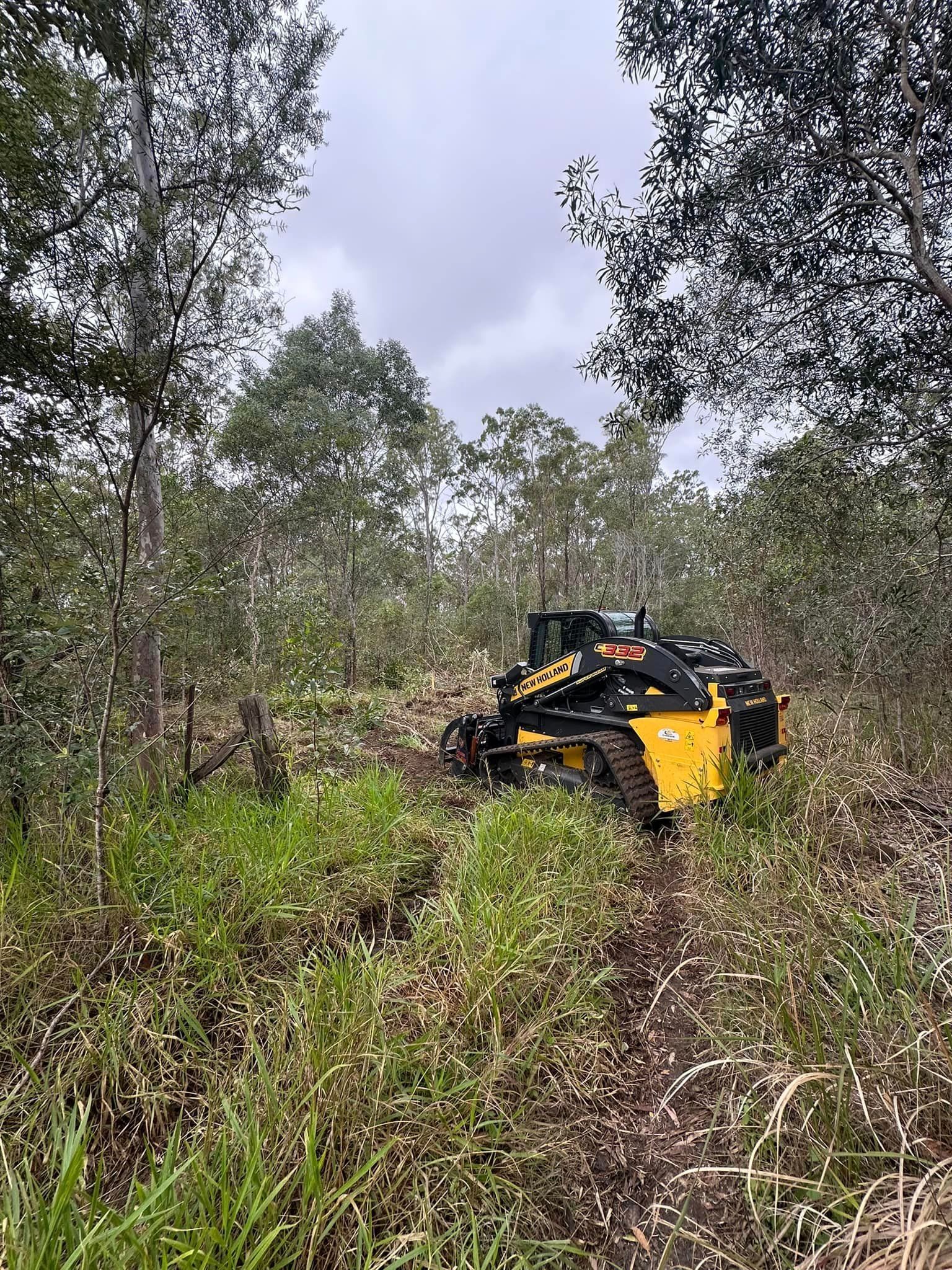 Forrest with Grass Debris and Yellow Machine— A1 Tree Service in Kensington, QLD