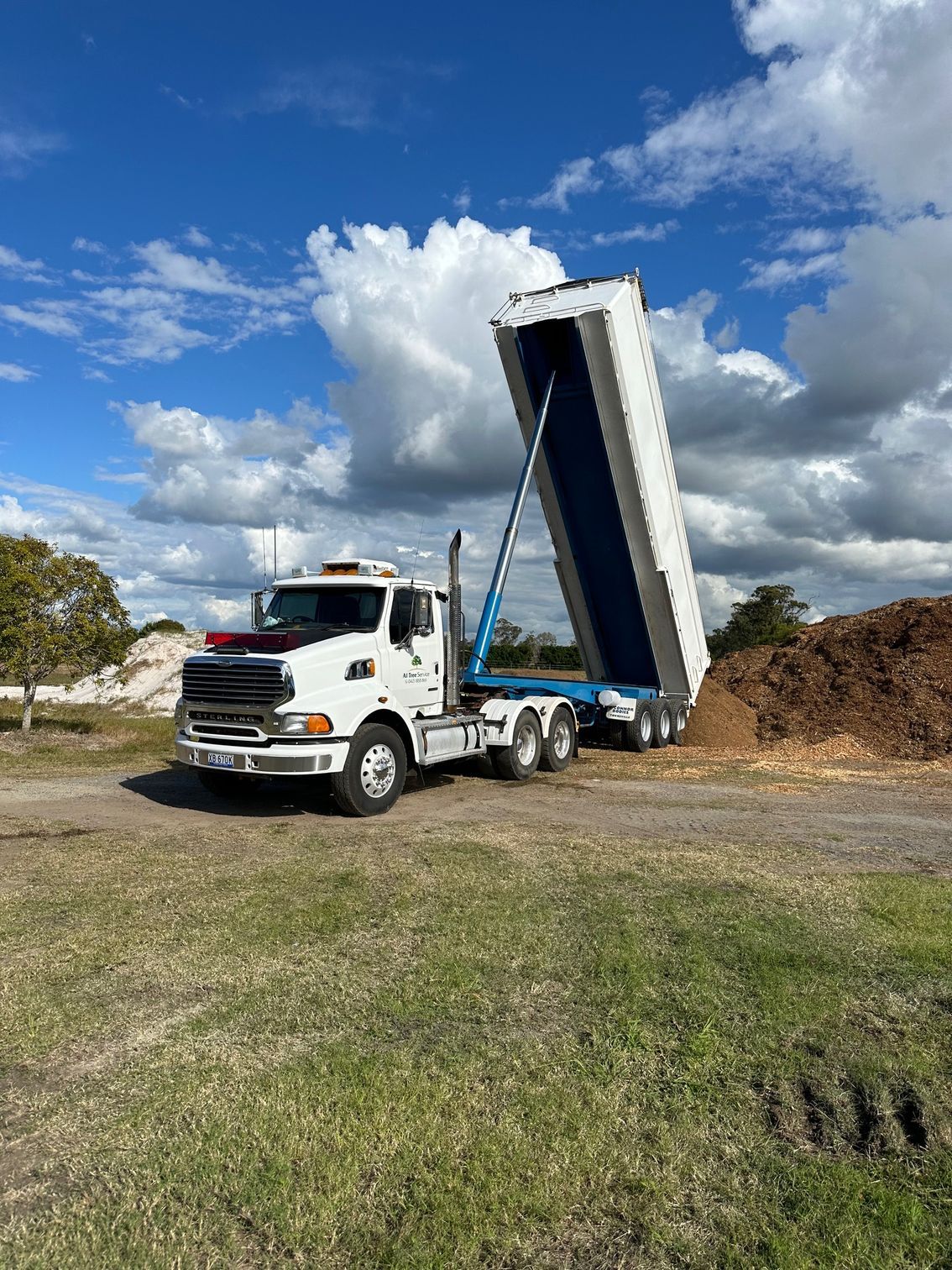A Dump Truck With a Large Amount of Dirt in It — A1 Tree Service in Gin Gin, QLD