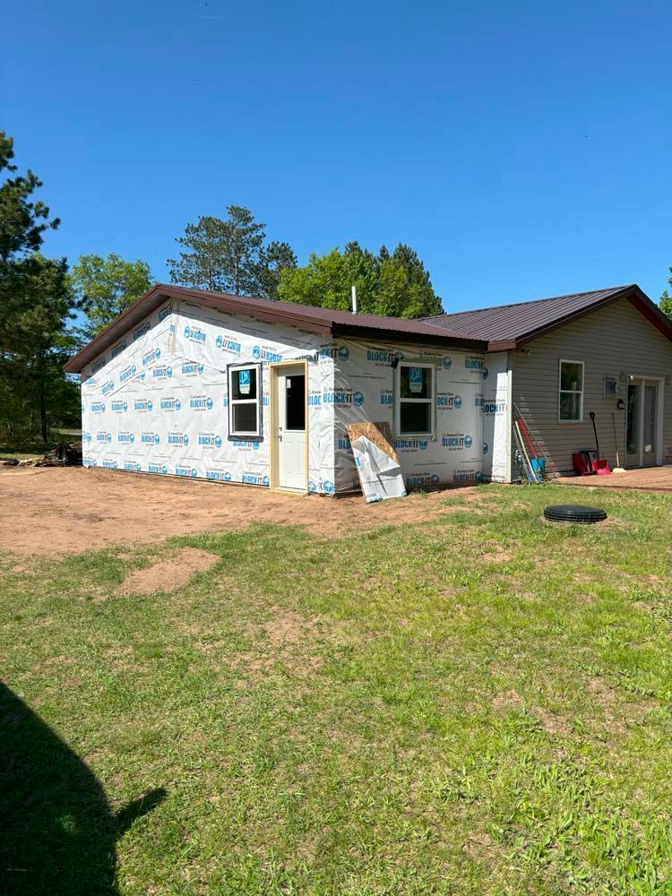 A house is being built in the middle of a grassy field.