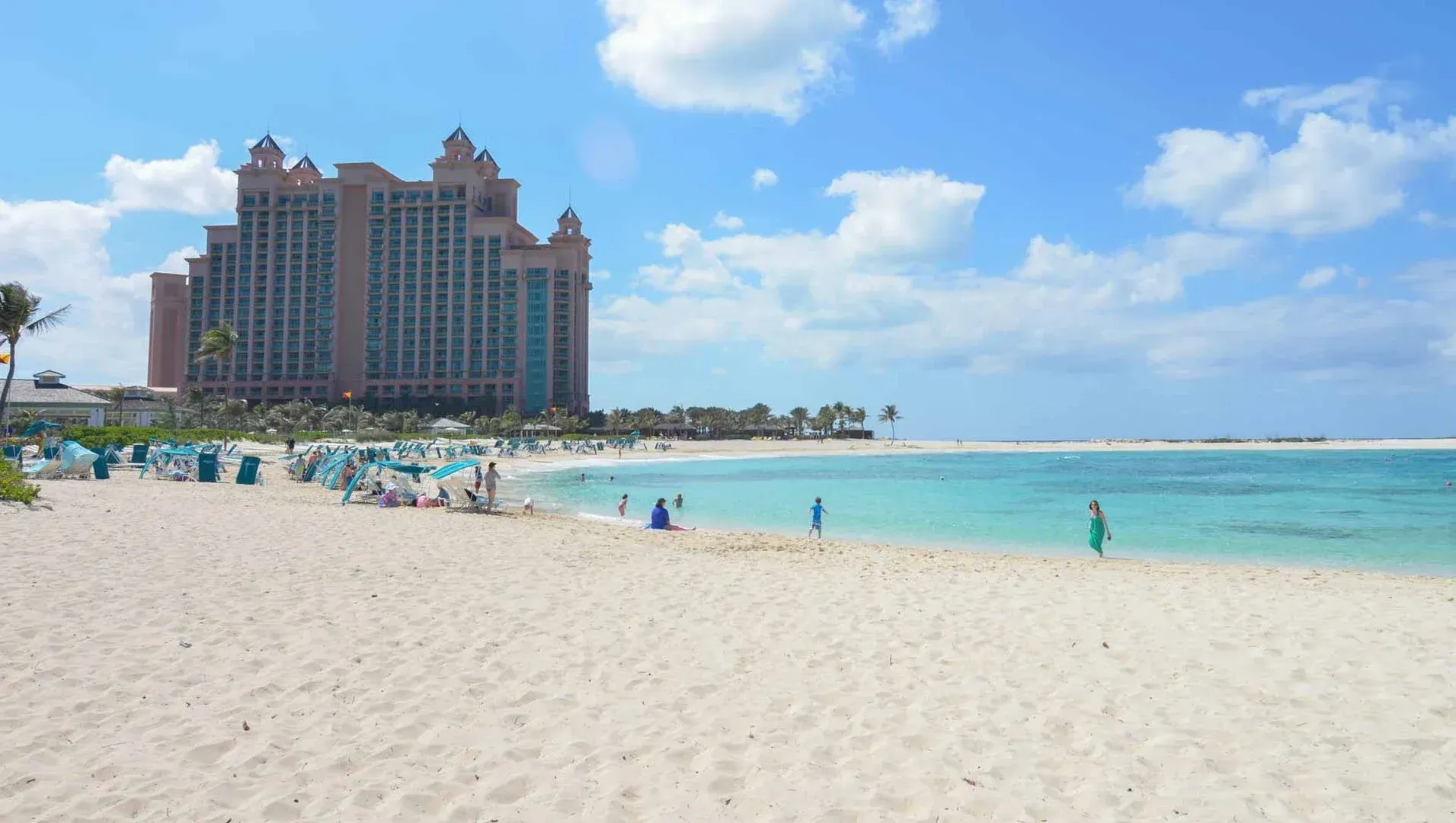 a beach with a large building in the background