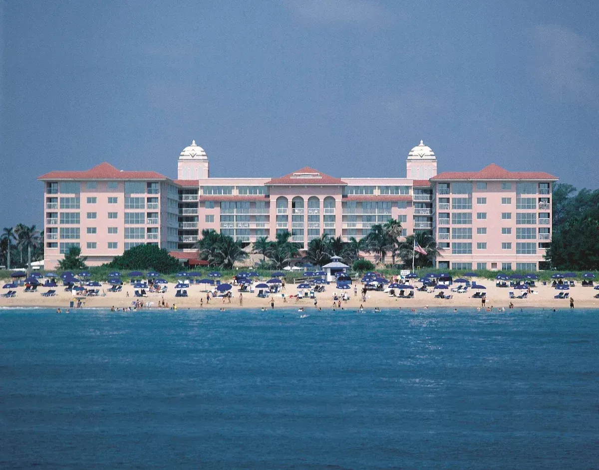 a large building with a beach in front of it