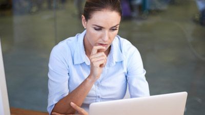 A woman sitting at a table using a laptop computer | Elgin, IL | 'I' in Team Series By IA Business Advisors