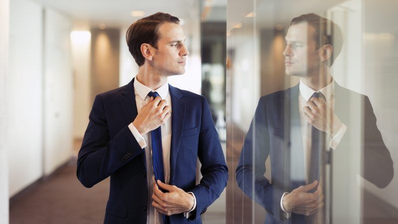 Businessman fixing his tie | Elgin, IL | 'I' in Team Series By IA Business Advisors