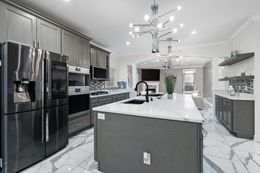 A kitchen with stainless steel appliances and a large island.