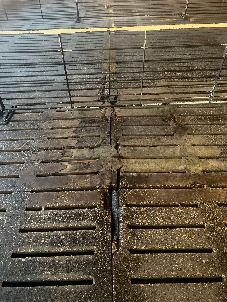 A dirty concrete floor with a yellow line in the middle