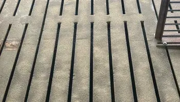 A close up of a fire escape with black stripes on it.