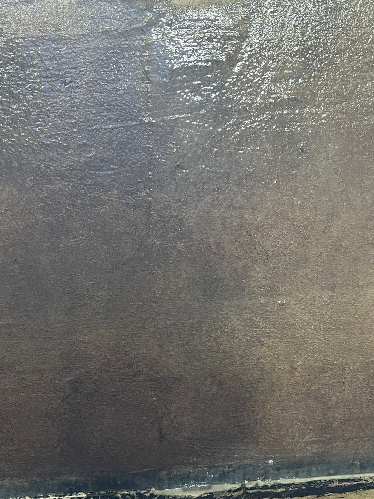 A close up of a gray surface with a lot of small dots on it.