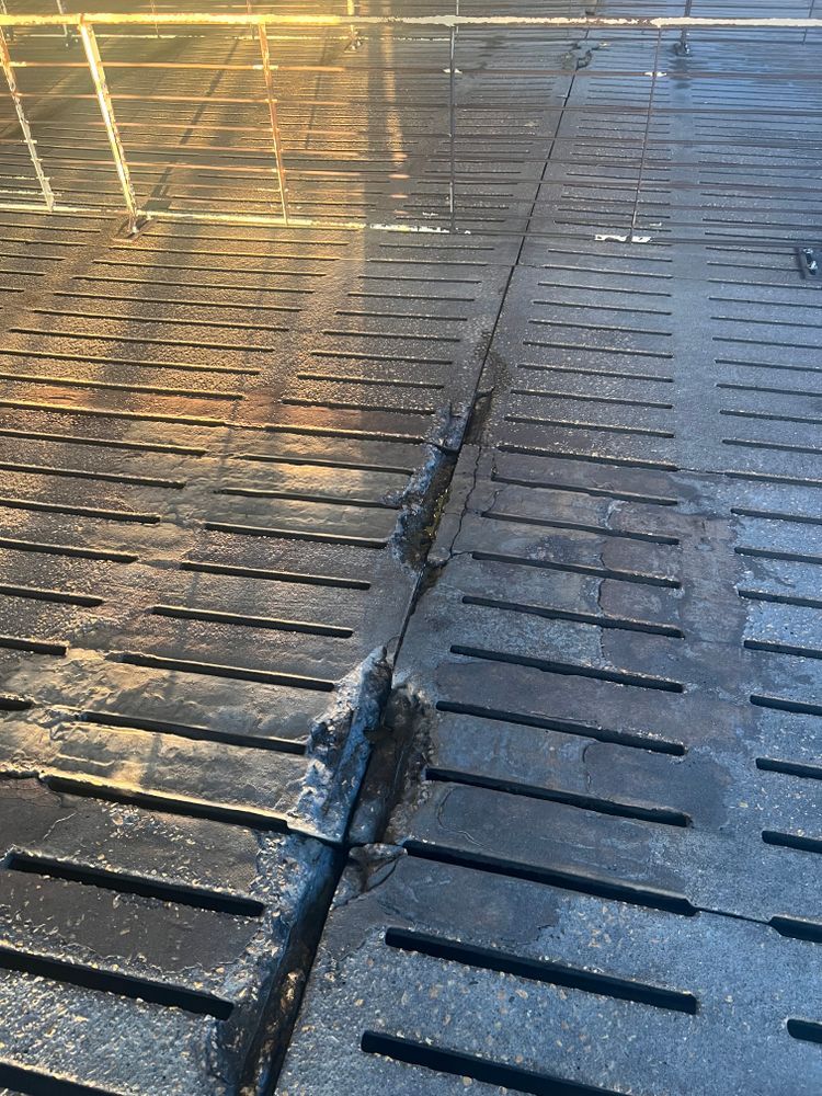 A close up of a drain on a concrete floor.