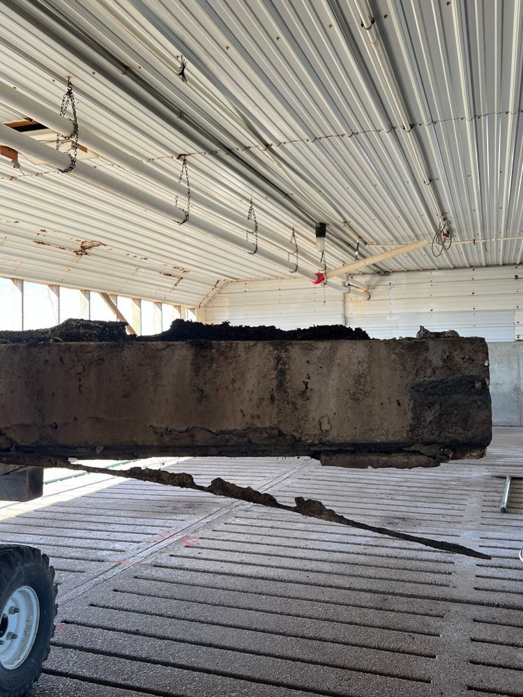 A large piece of wood is hanging from the ceiling of a building.