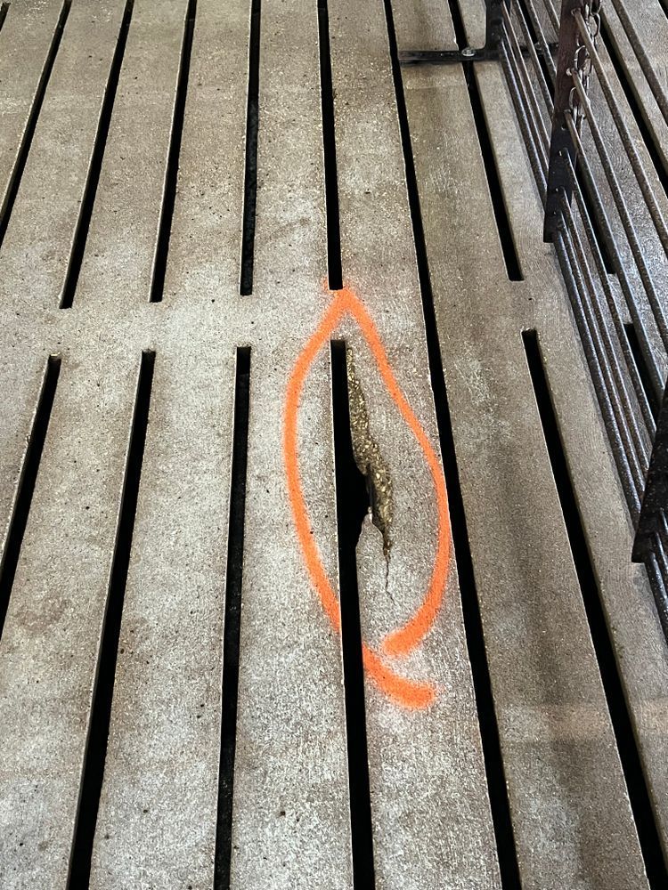 A close up of a concrete floor with a hole in it.