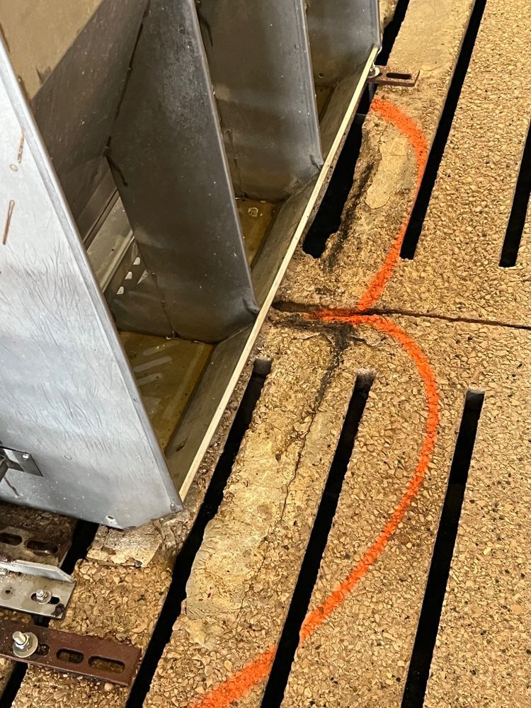 A close up of a concrete floor with a red line drawn on it.