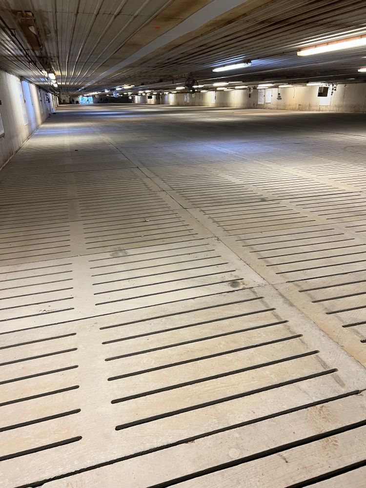 An empty parking garage with a lot of lines on the floor.